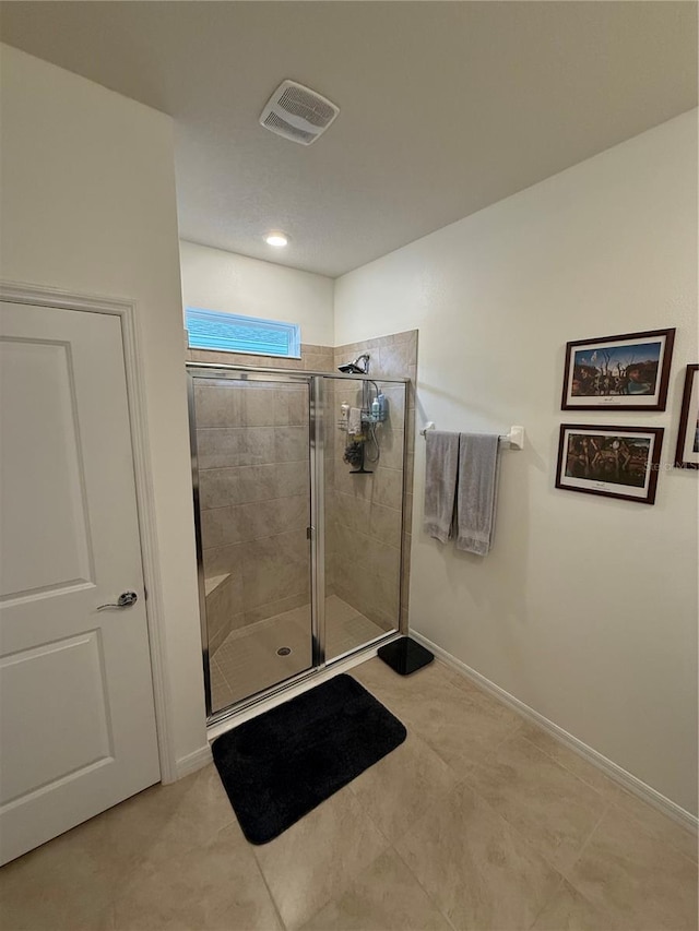 bathroom with a shower with shower door