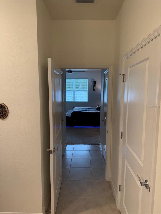 corridor featuring light tile patterned floors