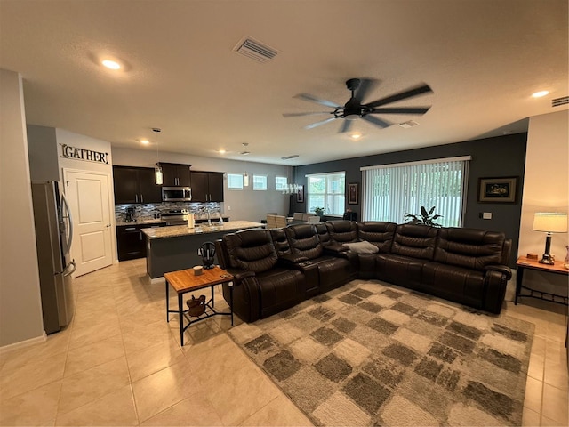 tiled living room with ceiling fan