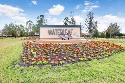 community / neighborhood sign with a lawn