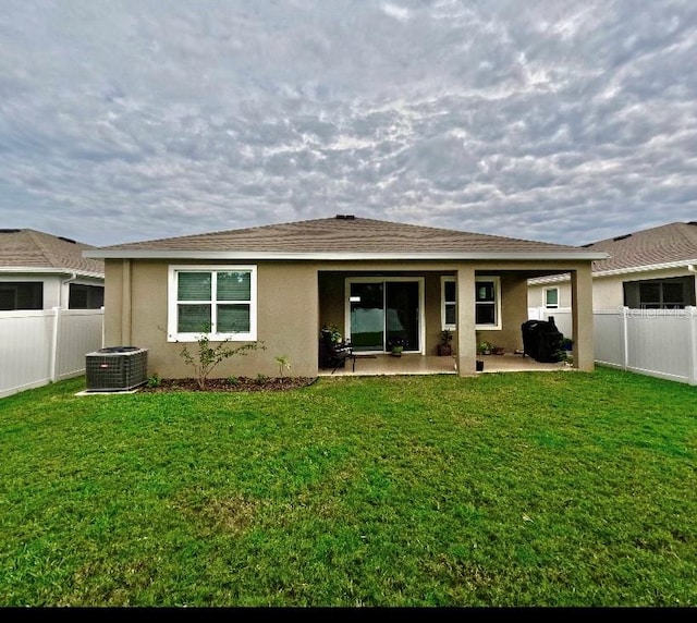 back of house featuring a patio area, a yard, and cooling unit