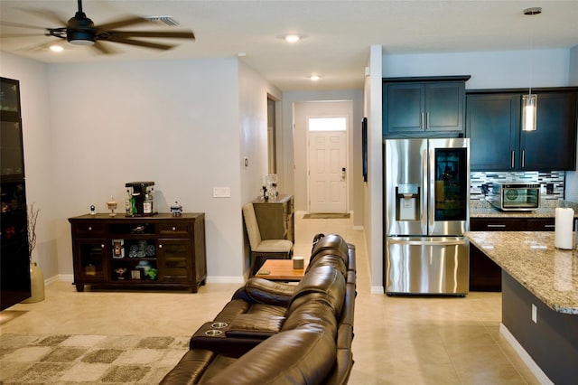 living room featuring ceiling fan and light tile patterned floors