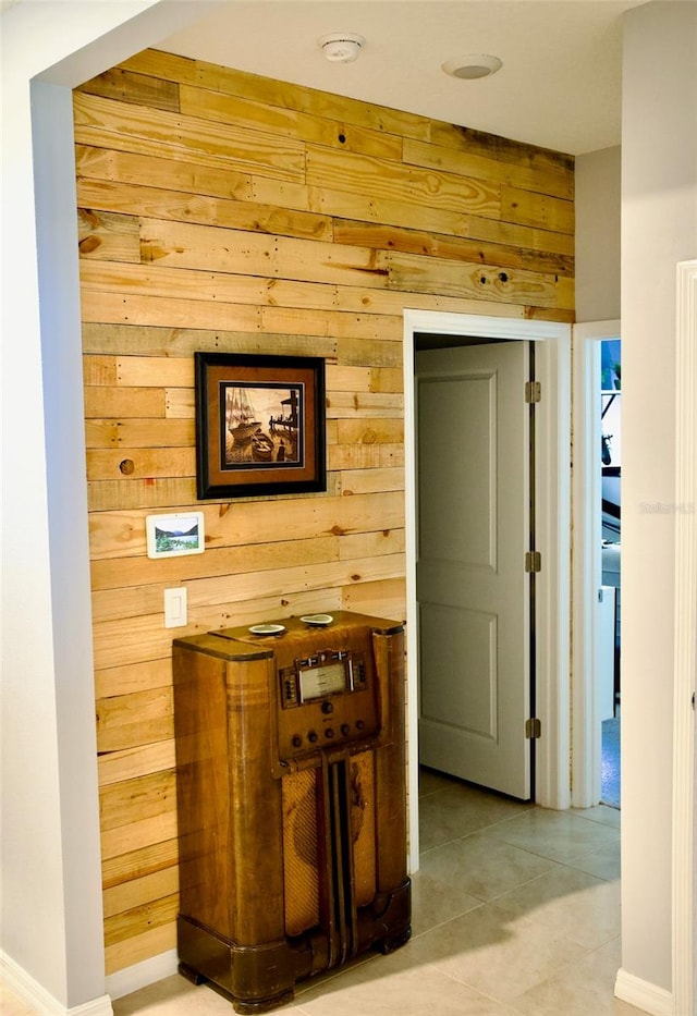 corridor featuring wooden walls