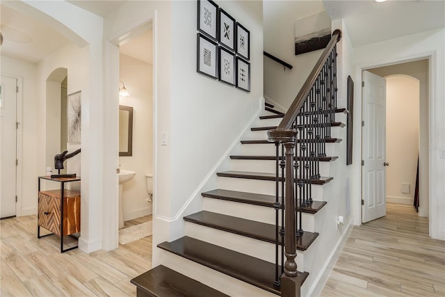 stairs featuring wood-type flooring