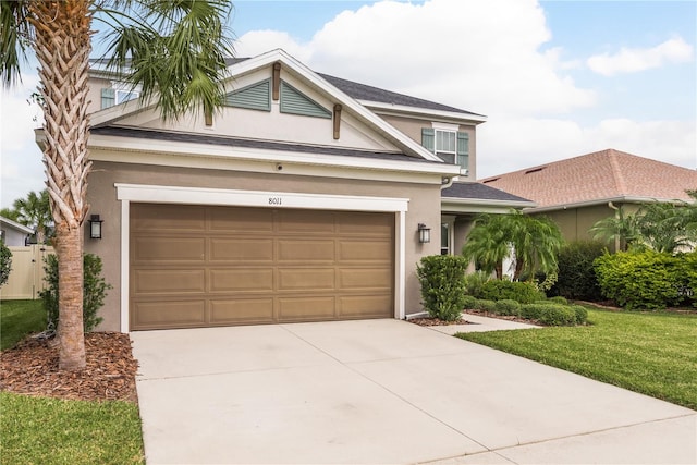 view of front of property with a garage and a front lawn