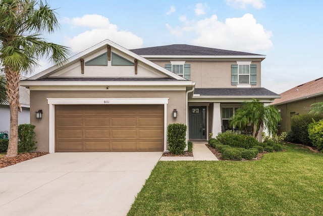 view of front of house featuring a garage and a front lawn