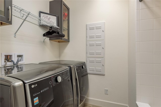 laundry area with cabinets and washing machine and dryer