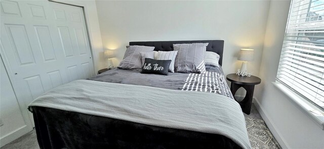 carpeted bedroom featuring a closet