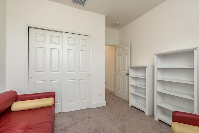 sitting room featuring light colored carpet