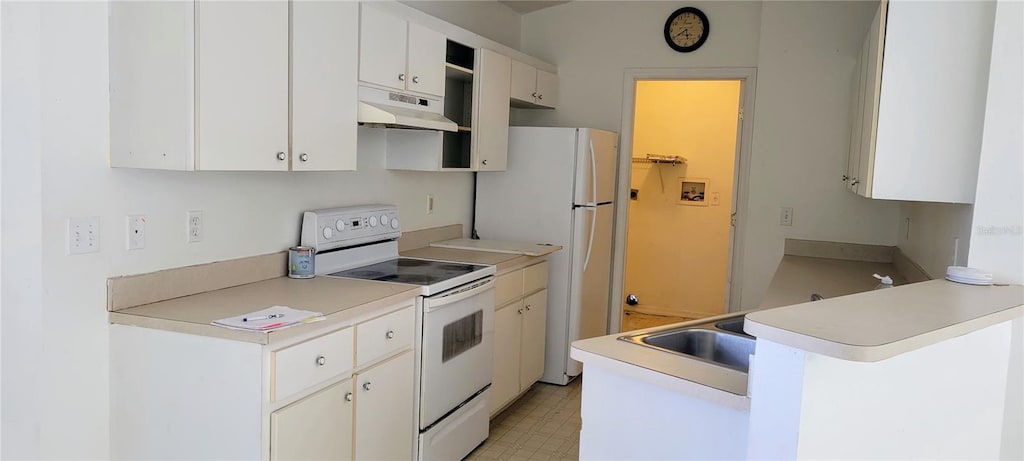 kitchen featuring white cabinetry, kitchen peninsula, and white appliances