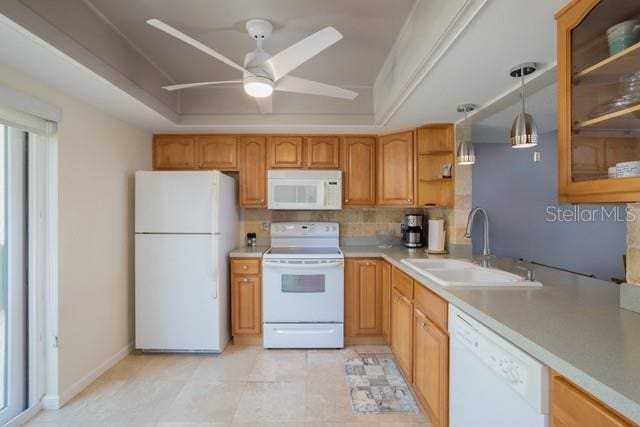 kitchen featuring sink, tasteful backsplash, ceiling fan, white appliances, and decorative light fixtures