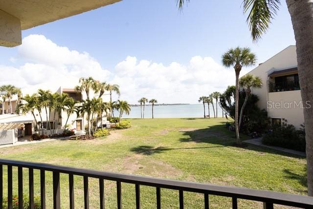 view of yard with a water view and a balcony