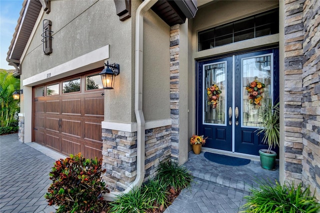 entrance to property with a garage and french doors