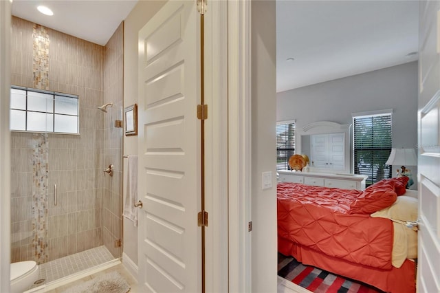 bathroom featuring a shower with shower door and plenty of natural light