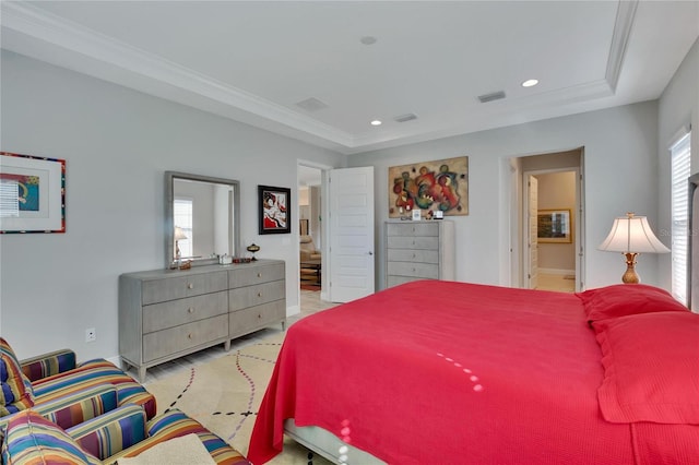 bedroom featuring ensuite bath, multiple windows, and crown molding