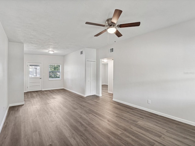 unfurnished room featuring dark hardwood / wood-style flooring, a textured ceiling, and ceiling fan