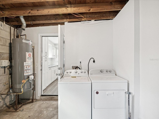 clothes washing area featuring washing machine and dryer and gas water heater