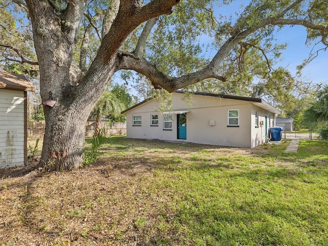 back of house with a lawn