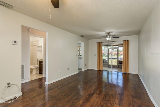 empty room with ceiling fan, visible vents, and wood finished floors