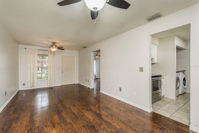 unfurnished living room with visible vents, light wood-style flooring, a ceiling fan, a textured ceiling, and washer and dryer