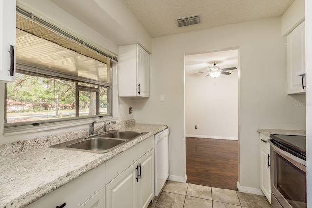 kitchen with a sink, visible vents, white cabinets, stainless steel electric stove, and dishwasher