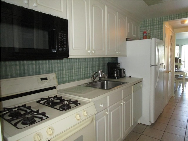 kitchen with white cabinetry, white appliances, sink, and light tile patterned floors