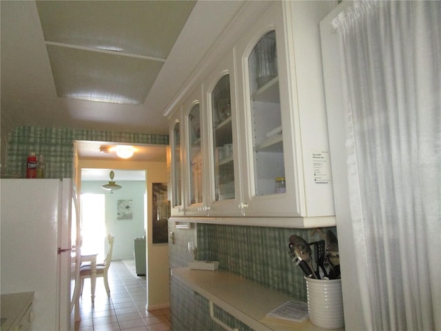 kitchen with white refrigerator and light tile patterned flooring