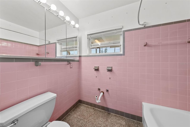 bathroom featuring bathtub / shower combination, tile walls, and toilet