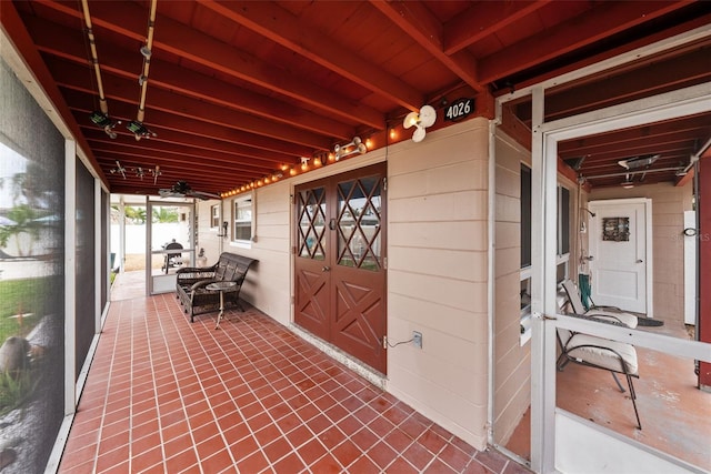 unfurnished sunroom with beamed ceiling