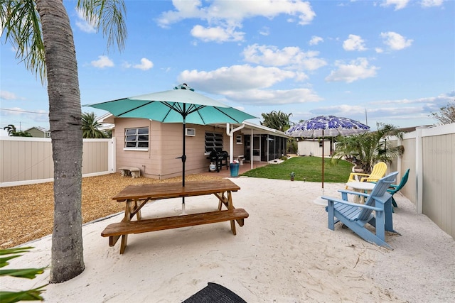 view of home's community with a lawn and a patio area