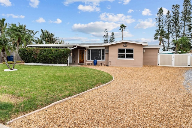 ranch-style house with a front lawn