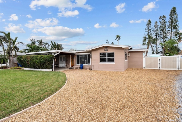 view of front of house with a front yard and a carport