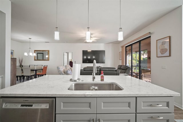 kitchen with sink, a kitchen island with sink, stainless steel dishwasher, dark hardwood / wood-style floors, and light stone countertops