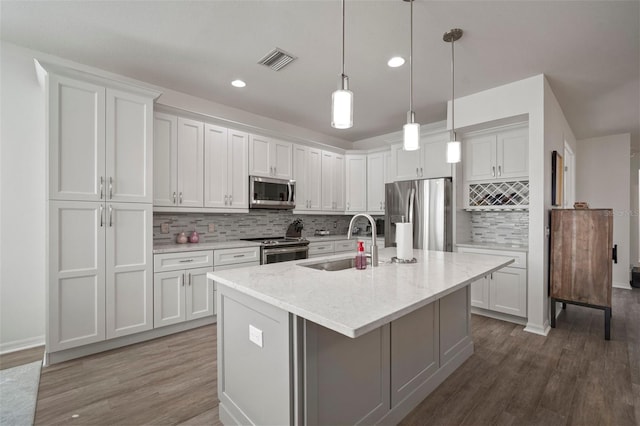 kitchen with white cabinets, sink, dark wood-type flooring, and appliances with stainless steel finishes