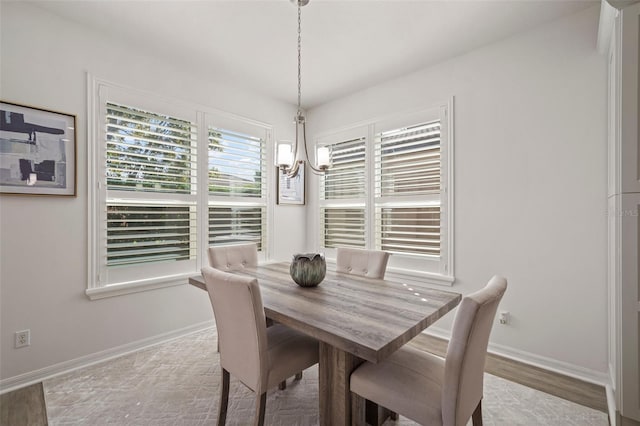 dining room featuring light hardwood / wood-style flooring and a notable chandelier