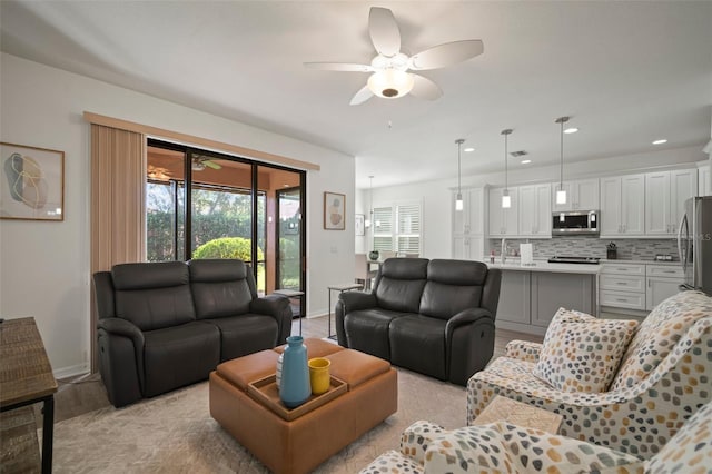 living room featuring light wood-type flooring and ceiling fan