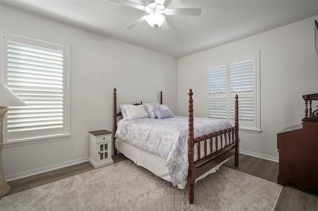 bedroom with dark wood-type flooring and ceiling fan