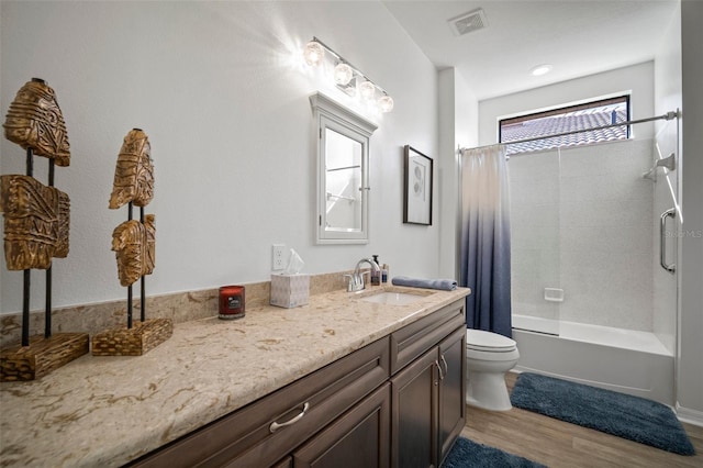 full bathroom with hardwood / wood-style flooring, shower / tub combo with curtain, vanity, and toilet