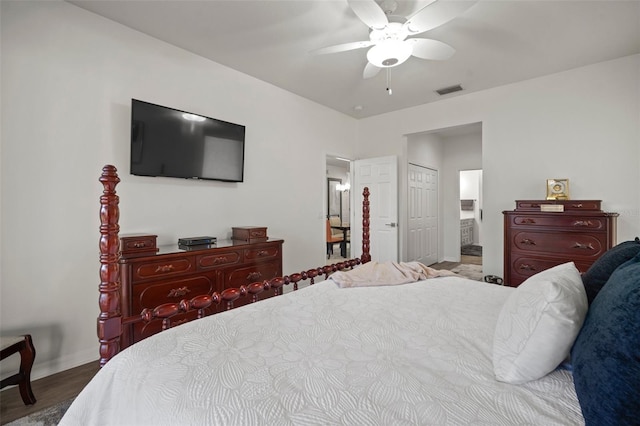 bedroom featuring hardwood / wood-style flooring, ceiling fan, and a closet