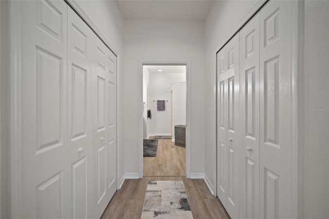 hallway with light wood-type flooring