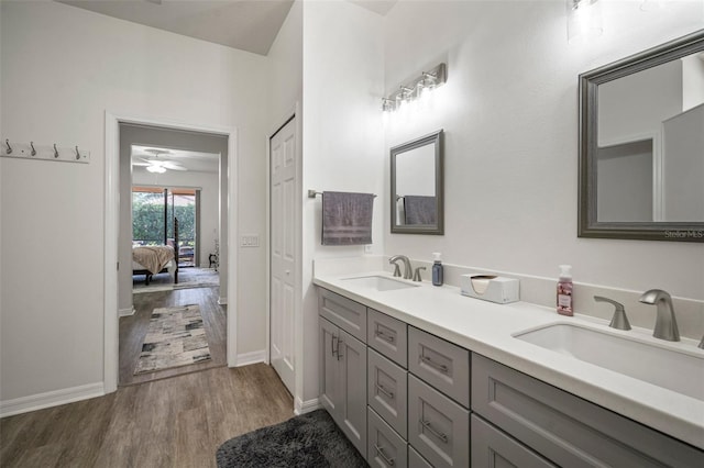 bathroom featuring hardwood / wood-style flooring, ceiling fan, and vanity