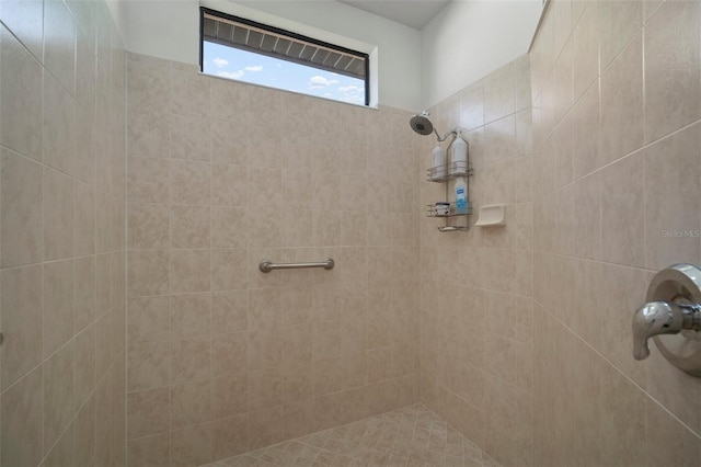 bathroom with a tile shower