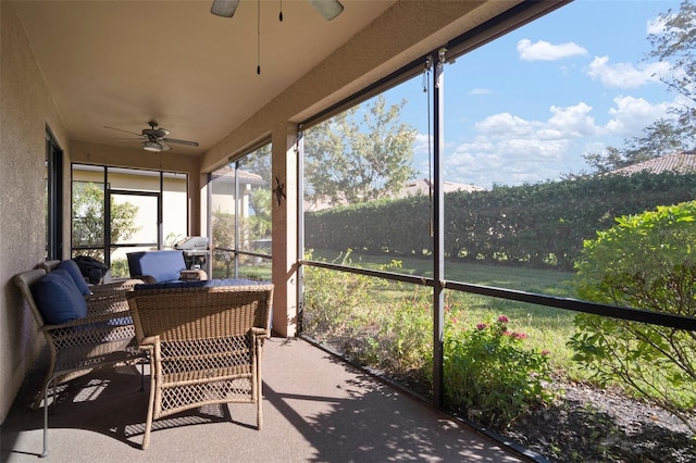 unfurnished sunroom featuring ceiling fan