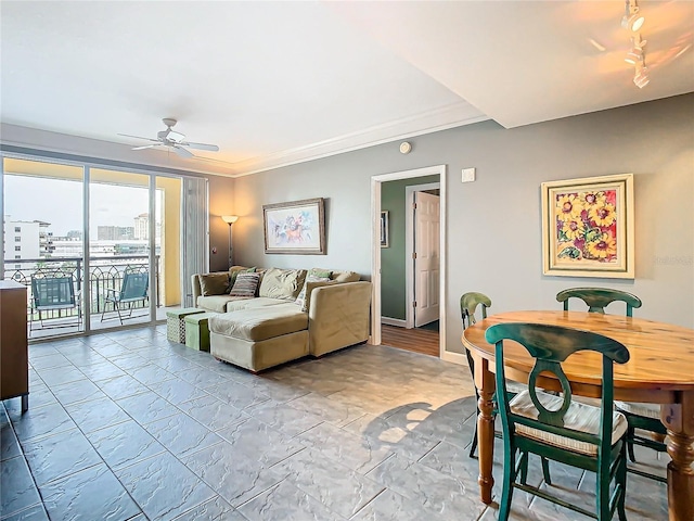 living room with ceiling fan and ornamental molding