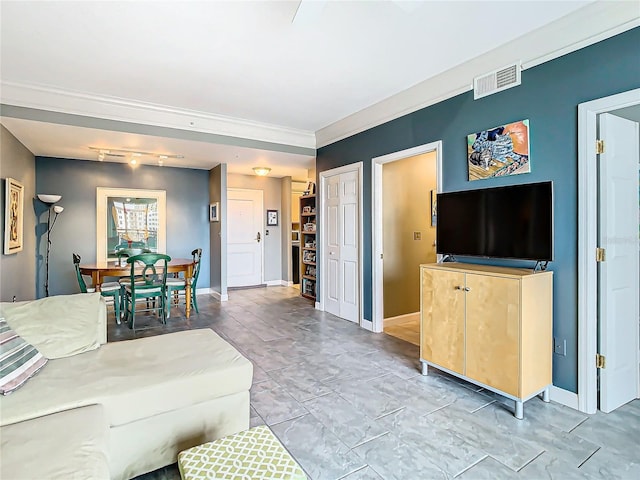 living room with rail lighting and ornamental molding