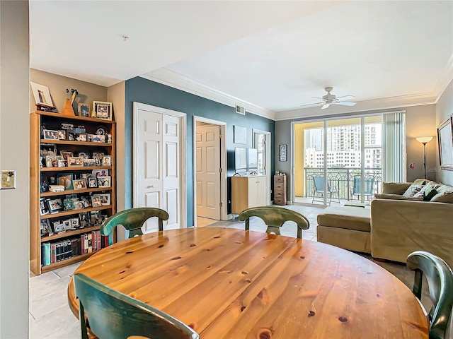 dining space with ceiling fan, crown molding, and light tile patterned floors