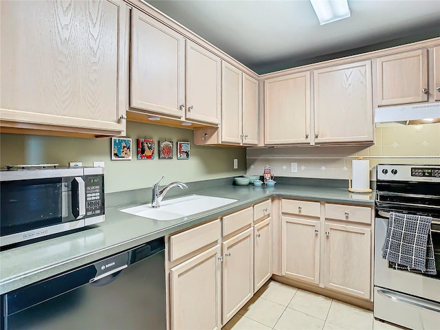 kitchen with sink, light tile patterned floors, stainless steel appliances, and tasteful backsplash