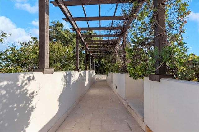 view of property exterior featuring a pergola and a patio