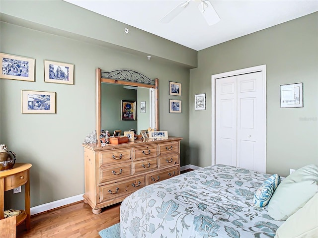 bedroom with light wood-type flooring, a closet, and ceiling fan