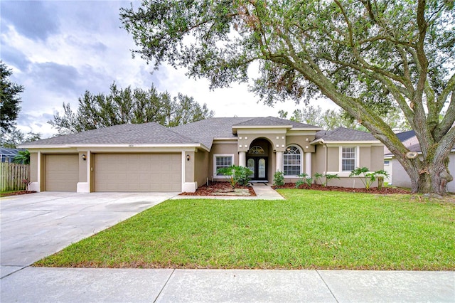 view of front of property featuring a garage and a front yard